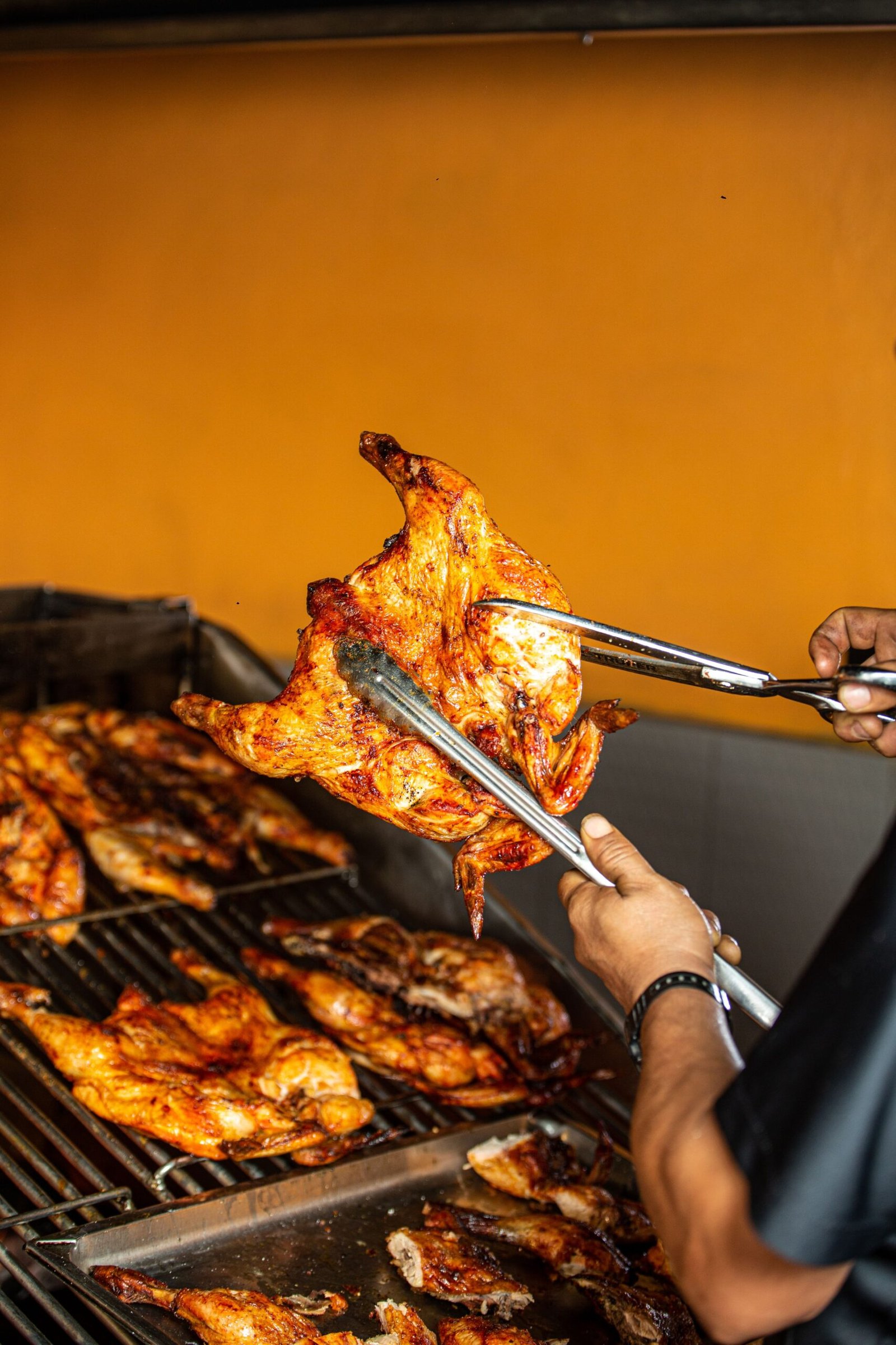 Grilled young chickens being carved (galeto)