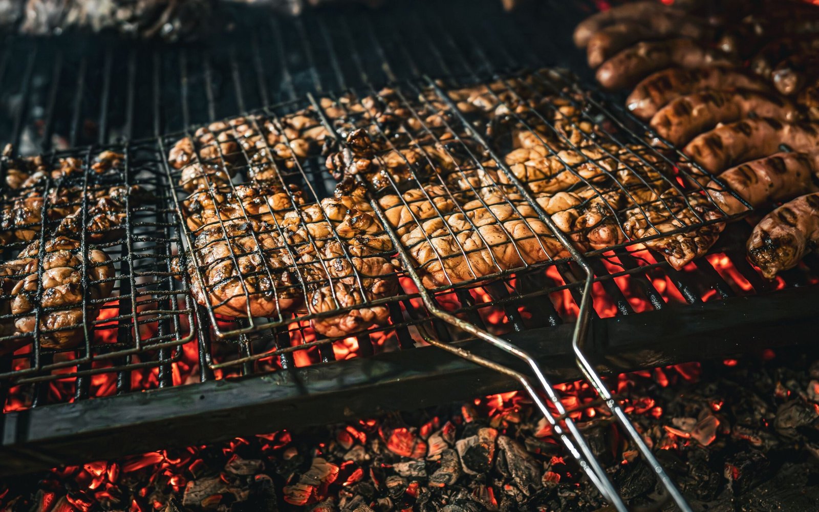 Chicken gizzards grilling over charcoal