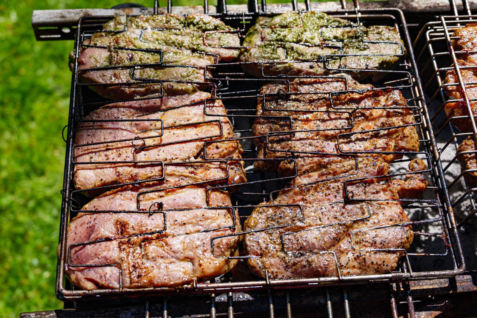 Pork loin steaks grilling over charcoal