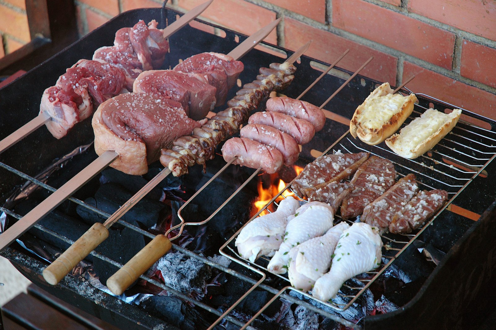 Meat cooking on a backyard charcoal grill