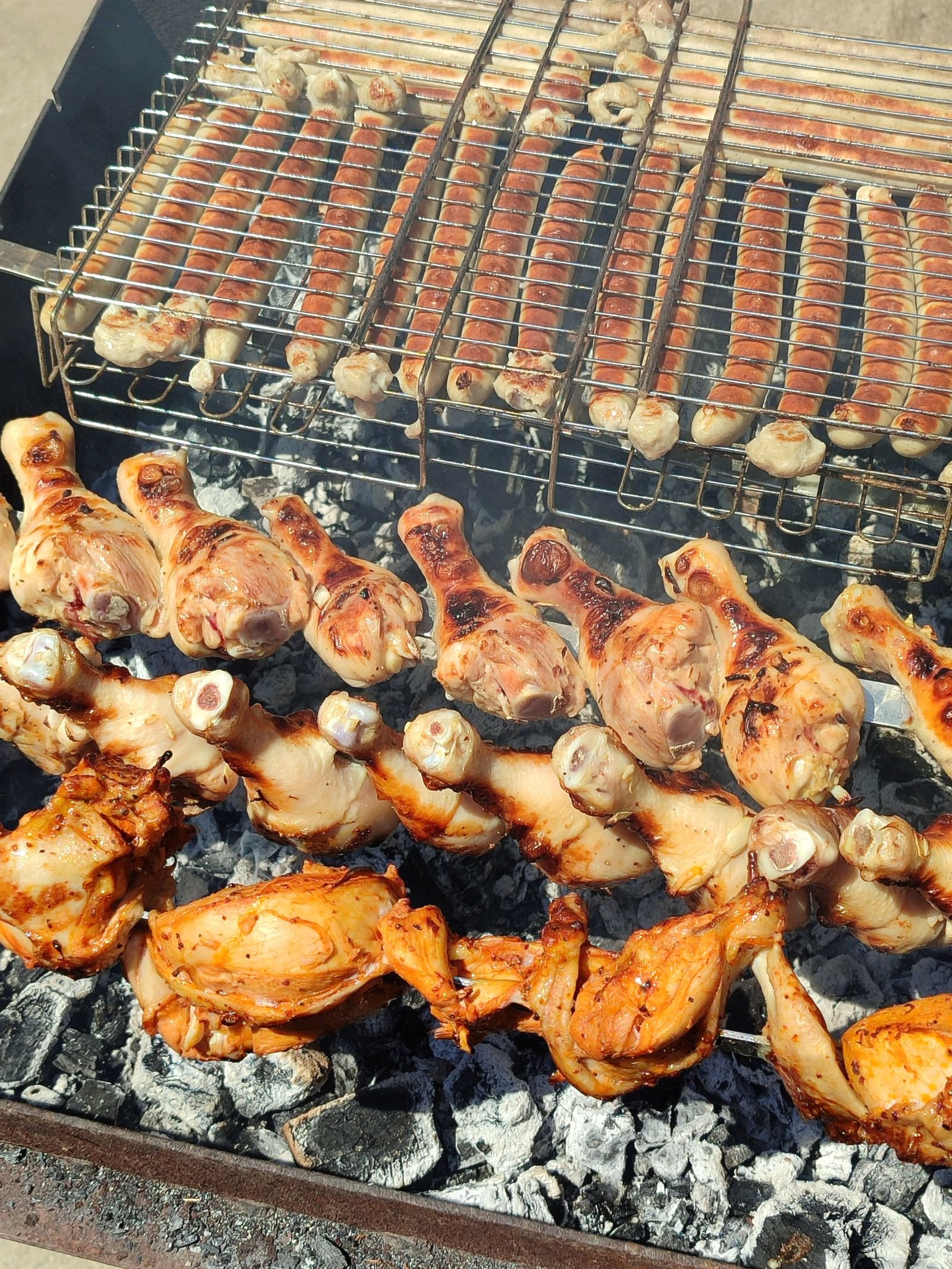 Chicken drumsticks and thighs over charcoal