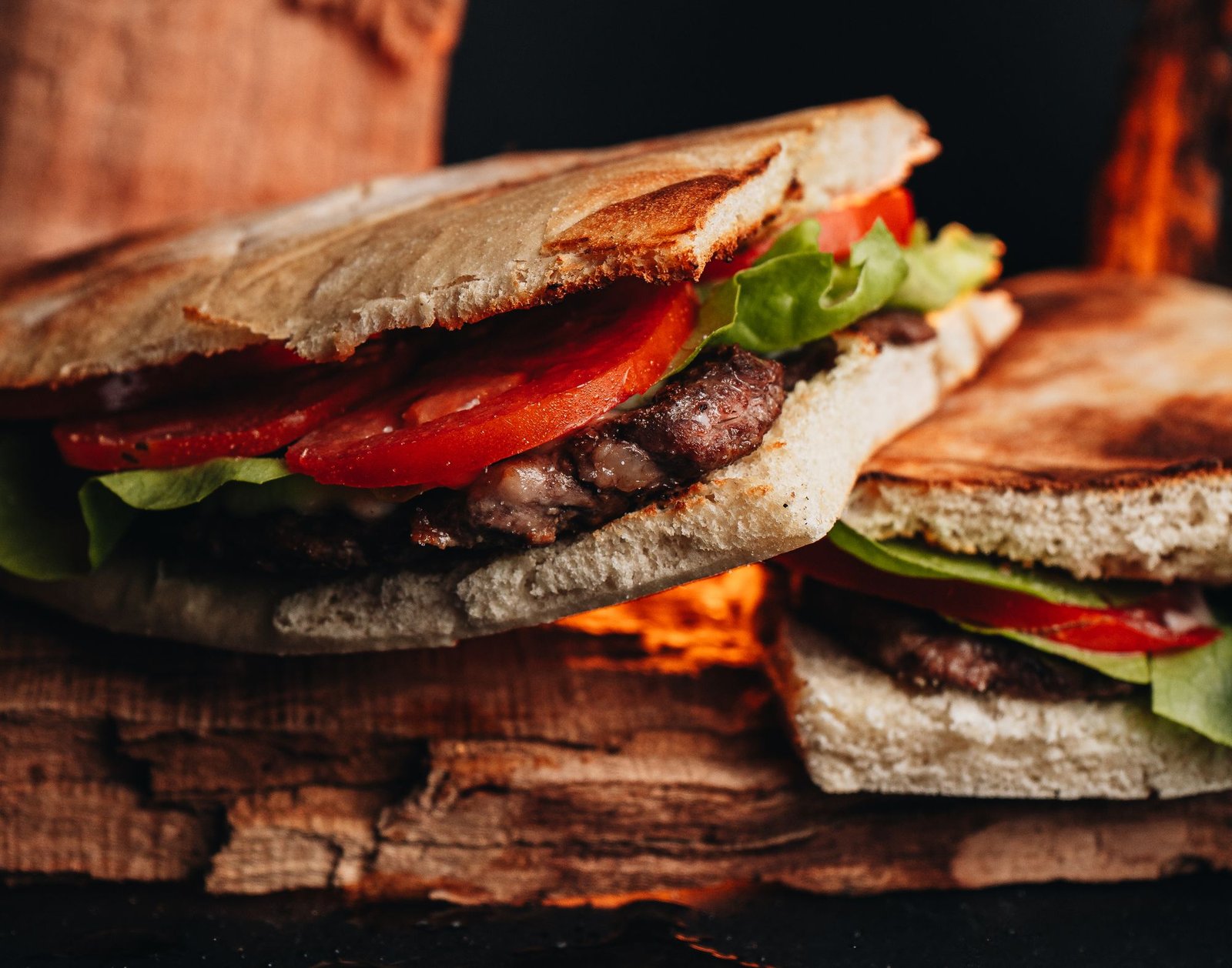 Steak sandwich on a toasted roll with lettuce and tomato