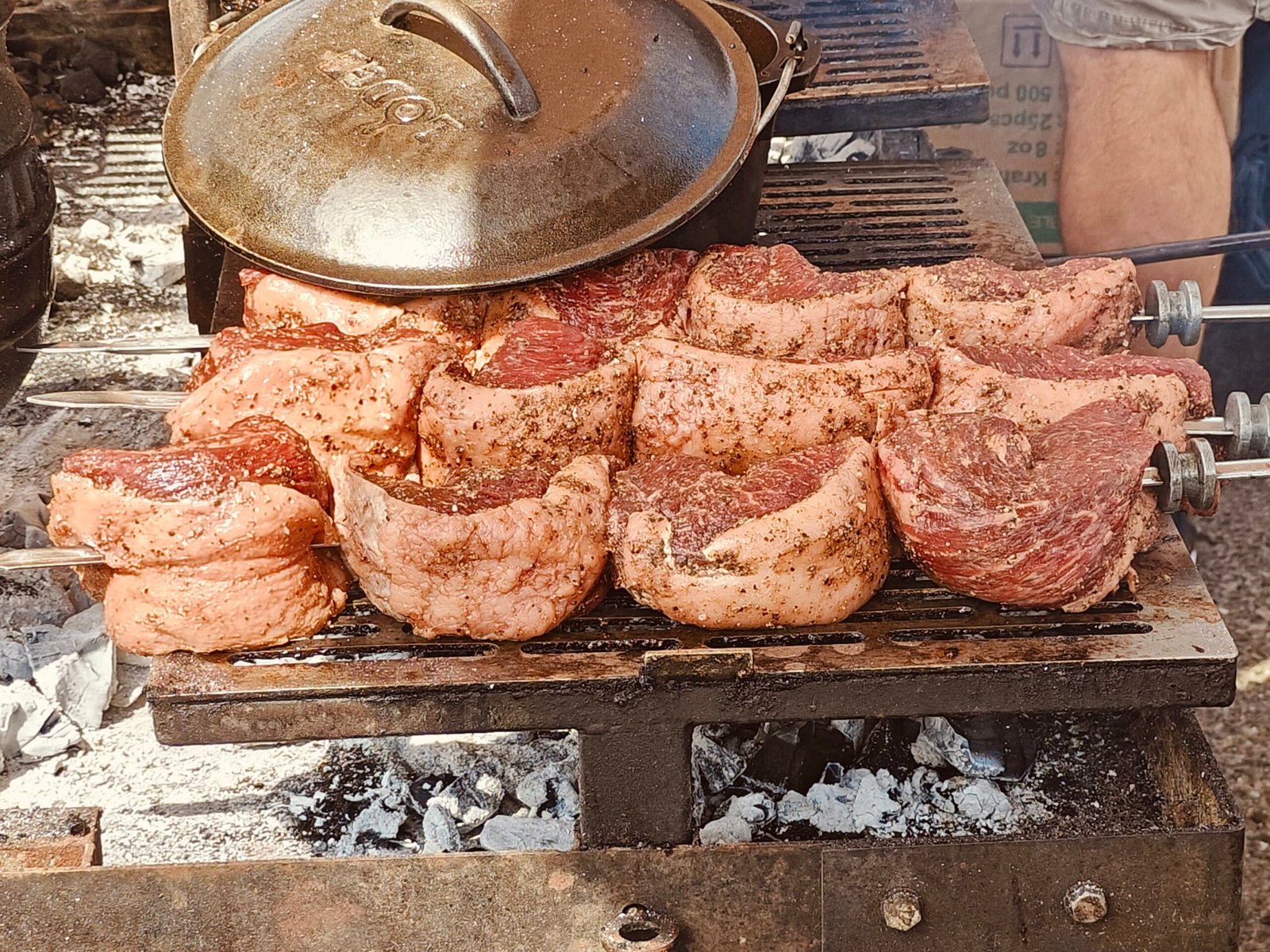 Picanha folded on metal skewers over charcoal