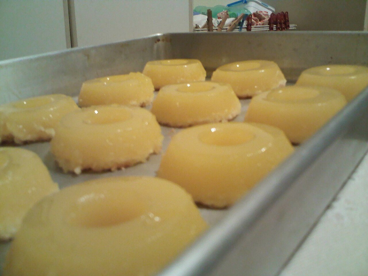 Tray of homemade Brazilian quindim: shiny yellow coconut egg-yolk custards with a coconut base