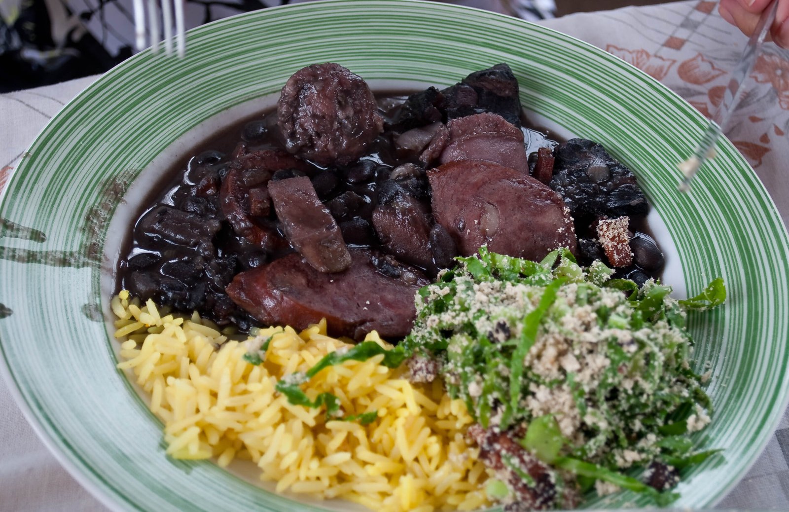 Feijoada completa with black beans, pork, rice, collard greens and farofa